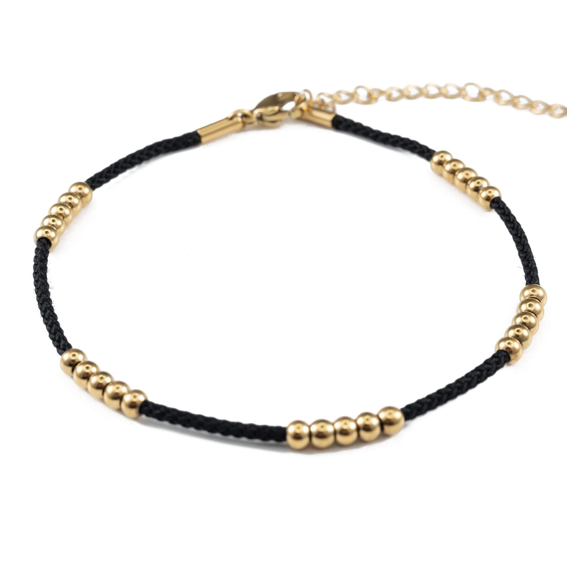 Black cord ankle bracelet with gold beads, made from medical steel, waterproof and stylish for daily wear.