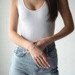 Model showcasing S925 silver bracelet with crystal, wearing a white top and light blue jeans.