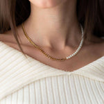 Hybrid pearl and chain necklace with 18K gold plating, worn elegantly, showcasing a stylish design.