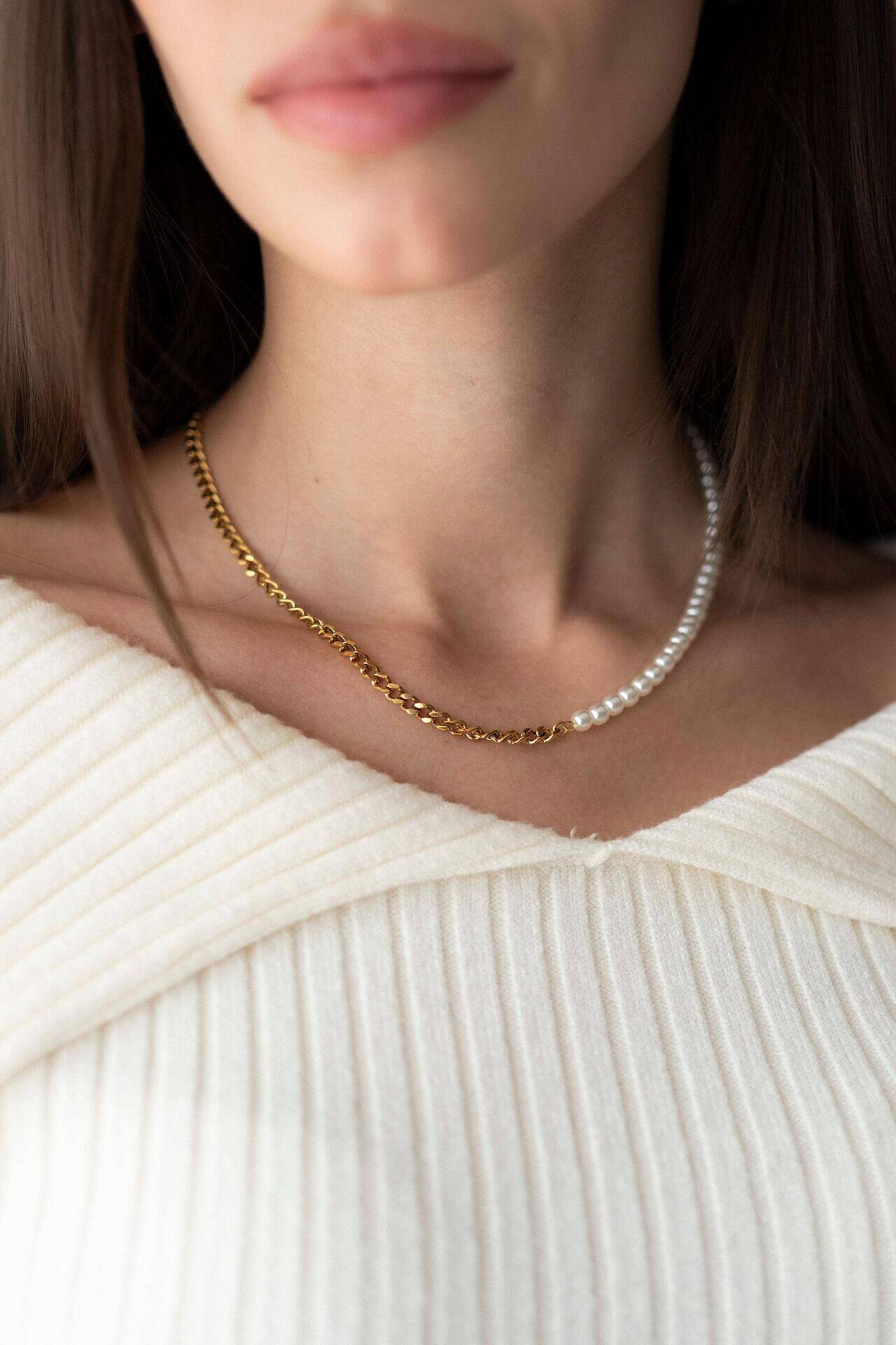 Hybrid pearl and chain necklace with 18K gold plating, worn elegantly, showcasing a stylish design.