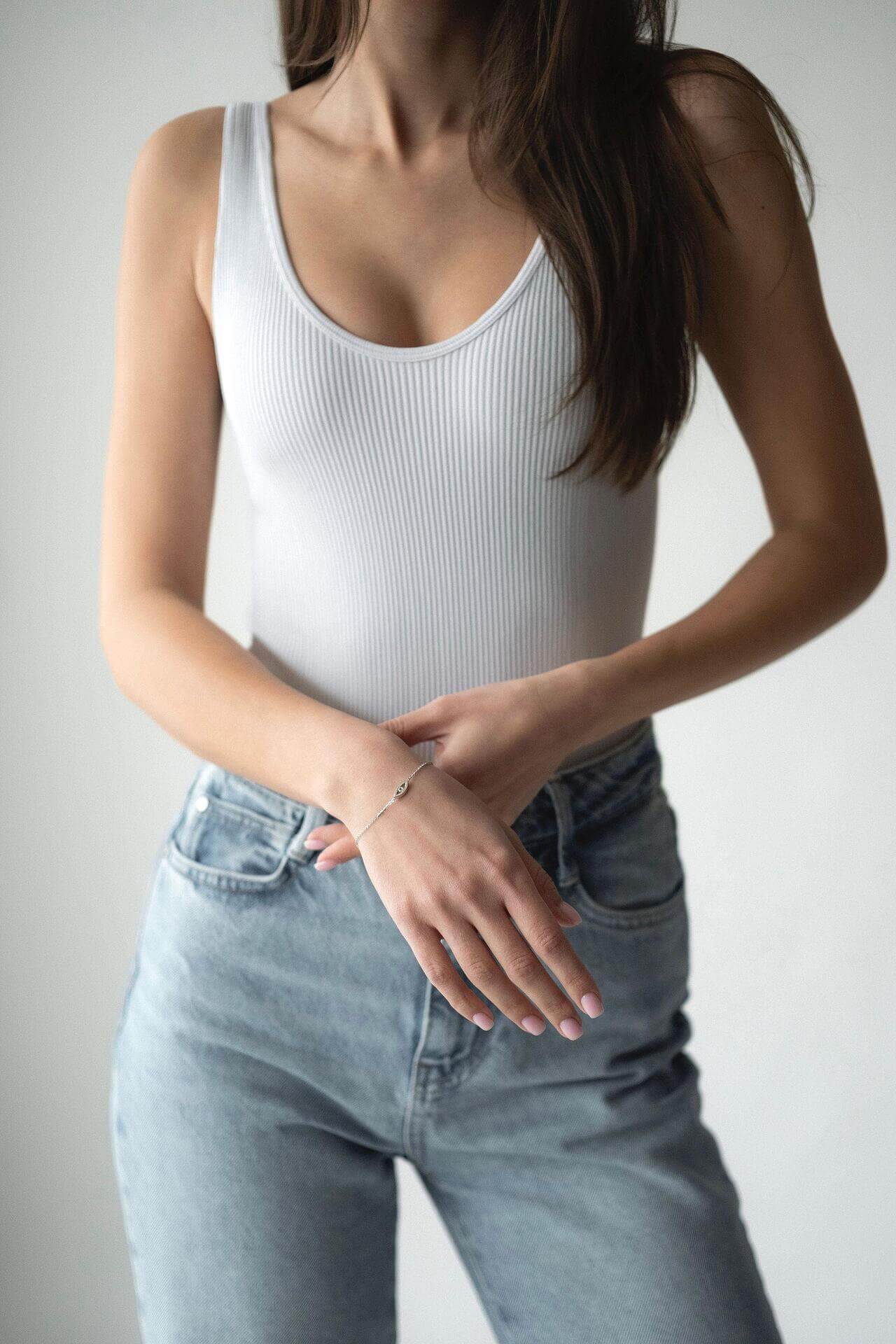 Model showcasing S925 silver bracelet with crystal, wearing a white top and light blue jeans.